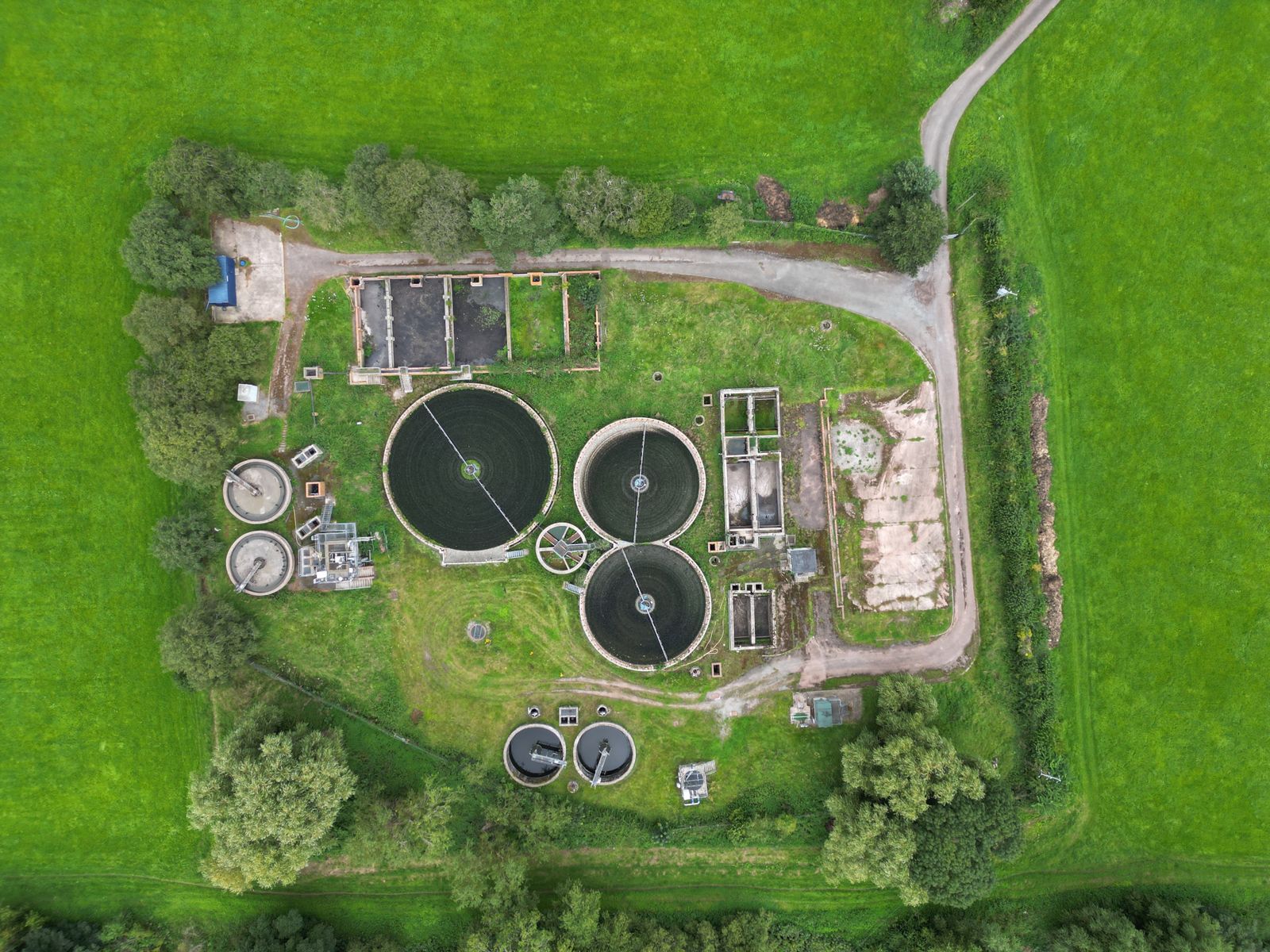Aerial view of a treatment facility in green fields